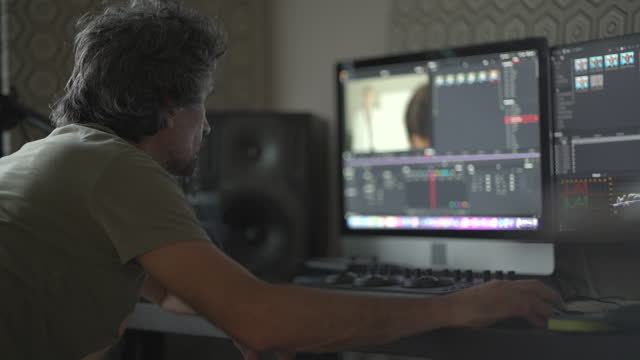 Mature man remote working - color grading video in editing software. Day in the life.