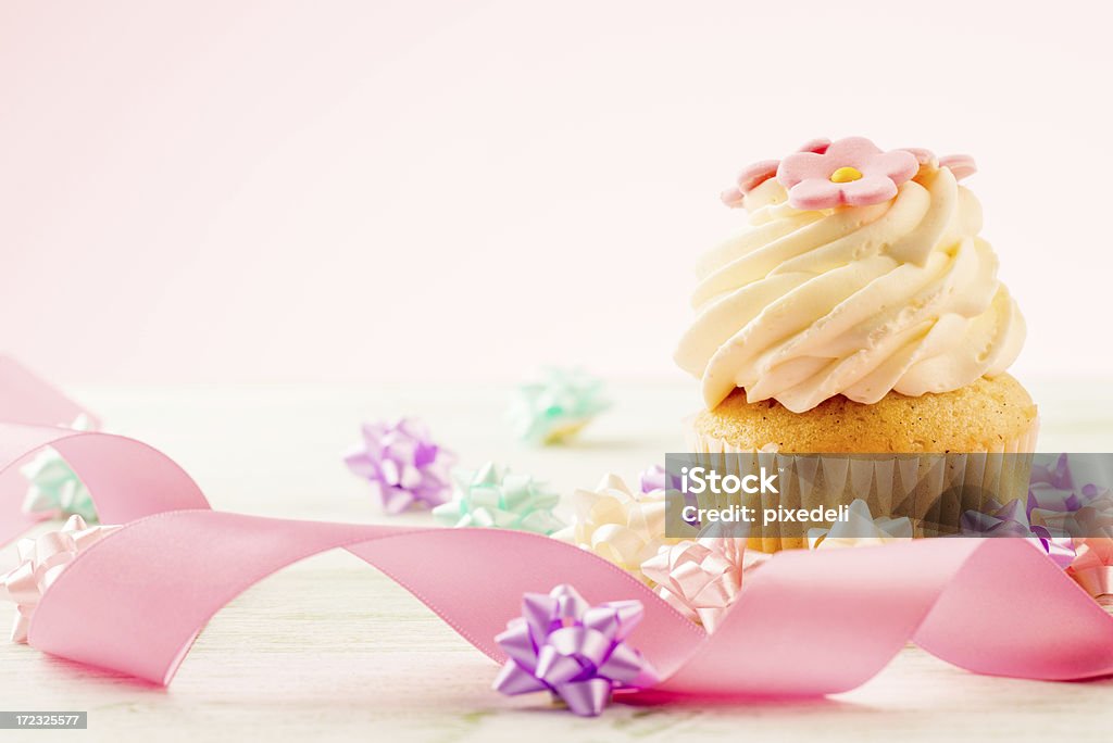 Cupcake with pink ribbon Cupcake with pink ribbon, celebration concept. Bright Stock Photo