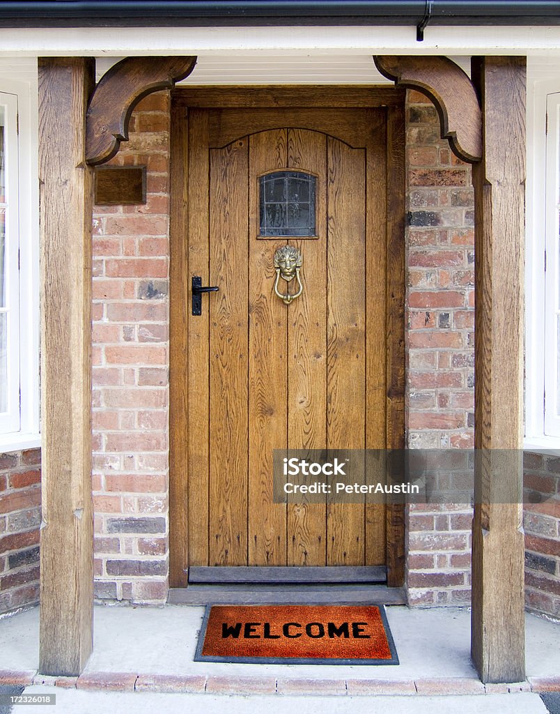 Welcome Old Oak Door with Welcome Mat. Front Door Stock Photo