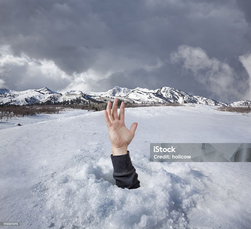 Help A hand reaches out from the frozen ice in a desperate call for help. Concept shot for financial, business or social help. Ice Stock Photo