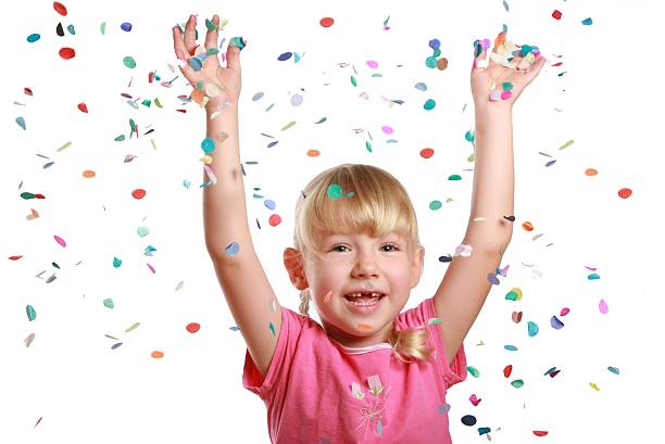 istock Little girl celebrating with falling confetti on white background 172328005
