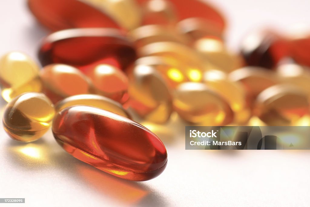 gel vitamin supplement capsules "Nutritional supplement pills in warm colors and shallow depth of field. The yellow ones are vitamin E and cod liver oil, and the larger ones are lecithin.You may also like:" Beauty Stock Photo