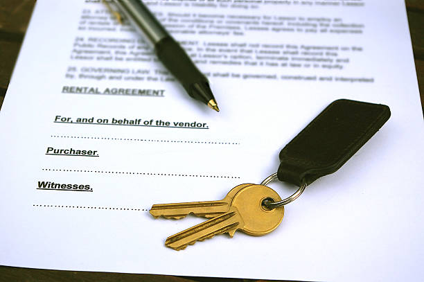 Rental agreement contract with pen and keys. stock photo