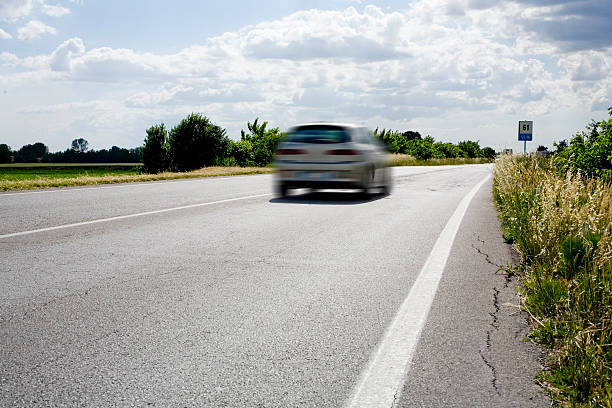 istock street with a fast car 172328484
