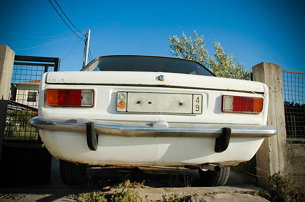 istock Rear of an old white car under blue sky 172328790