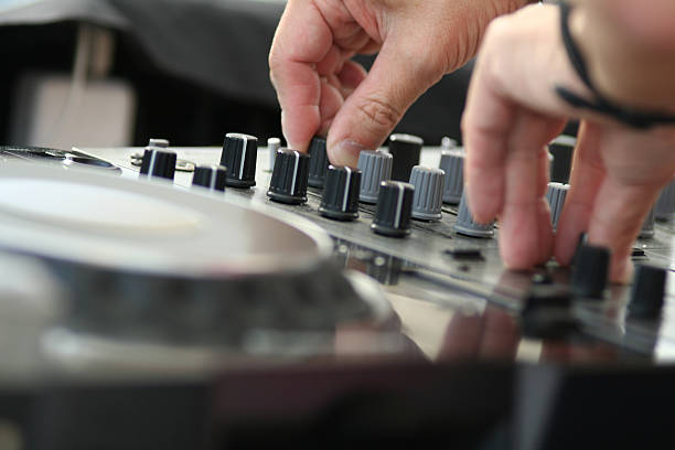 istock Hands turning dials on sound mixing machine 172329022