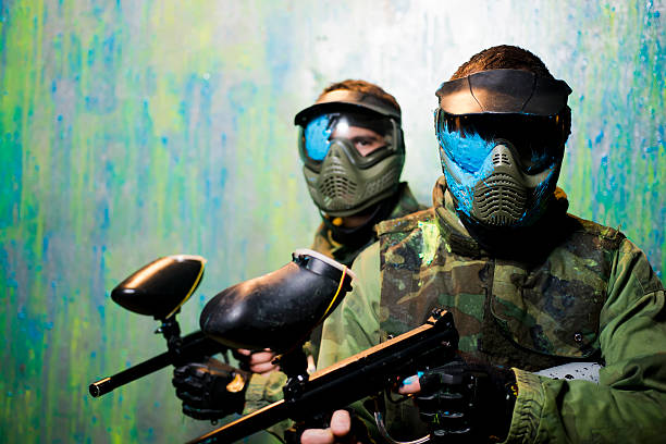 Paintball players with protective masks Close up of paintball players with paint on  protective mask face guard sport photos stock pictures, royalty-free photos & images