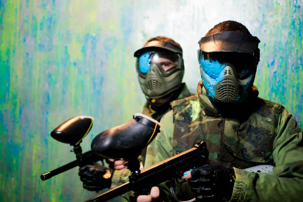 Paintball players with protective masks Close up of paintball players with paint on  protective mask paintballing stock pictures, royalty-free photos & images