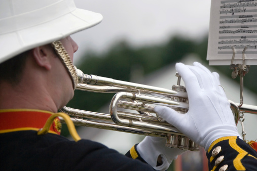 military musican blowing trumpet