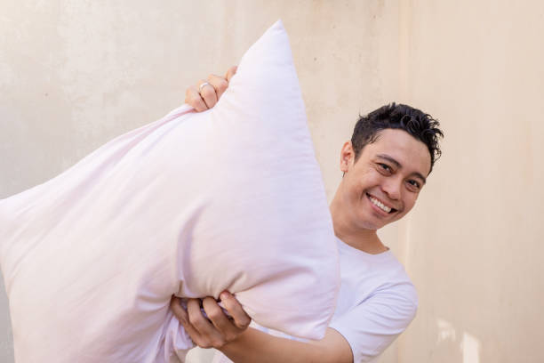 istock Indonesian man pose and gesture when pillow fight with friend, with happy expression. 1723295337