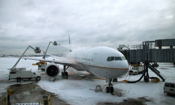 istock Winter Travel Delay: de-icing an airplane during a blizzard / snowstorm 172329626