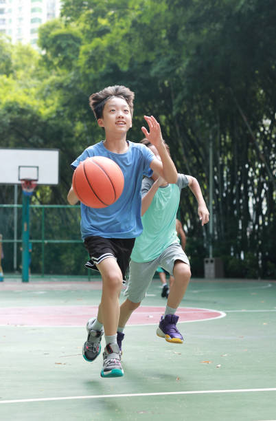 istock Asian boy playing basketball outdoors 1723296416