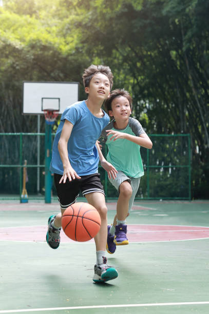 istock Asian boy playing basketball outdoors 1723296423