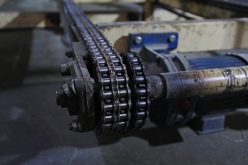 The greasy drive chain is in the factory
