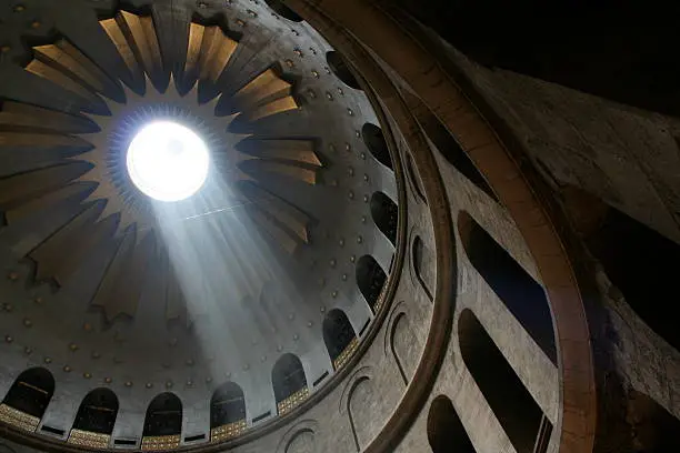 Light streams through the opening of the Church of the Holy Sepulchre in Jerusalem.