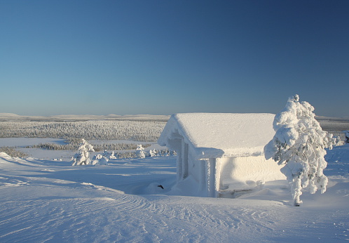 Frozen cabin on a hill.