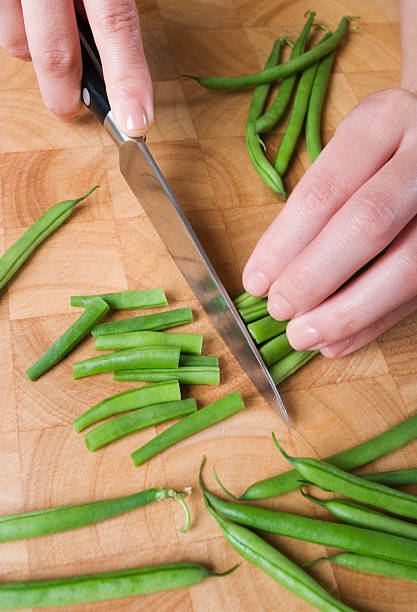 Chopping green beans.