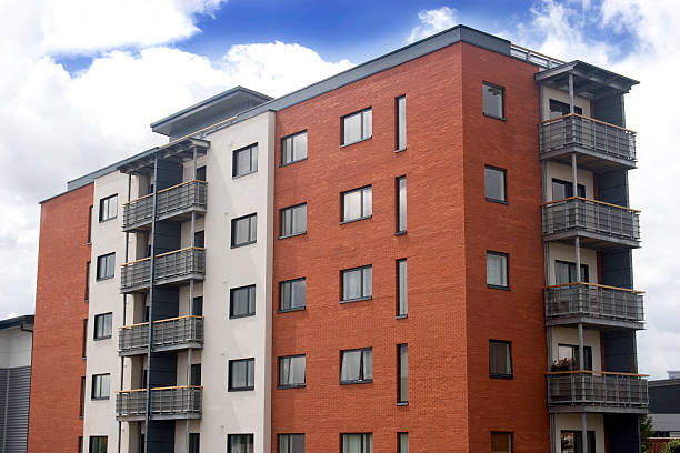 Element of the facade of a modern residential apartment building made of yellow brick.