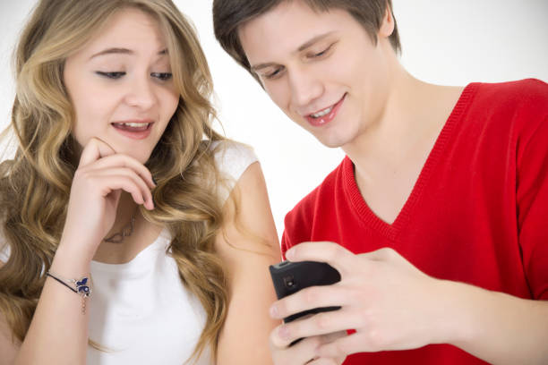 istock Young couple having fun with mobile phone 172332555