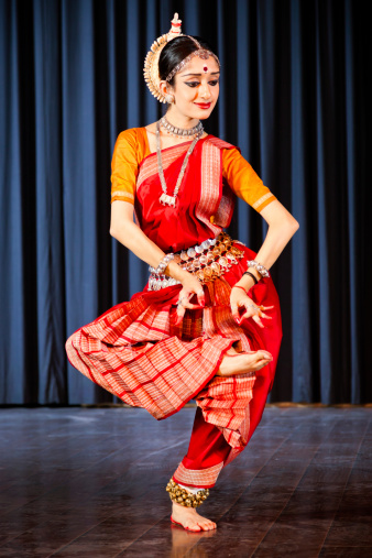 Indian woman dancing traditional danceKuchipudi dancer performing on stage