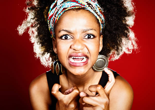 istock Furious young afro-haired woman grimacing with clenched fists 172332598