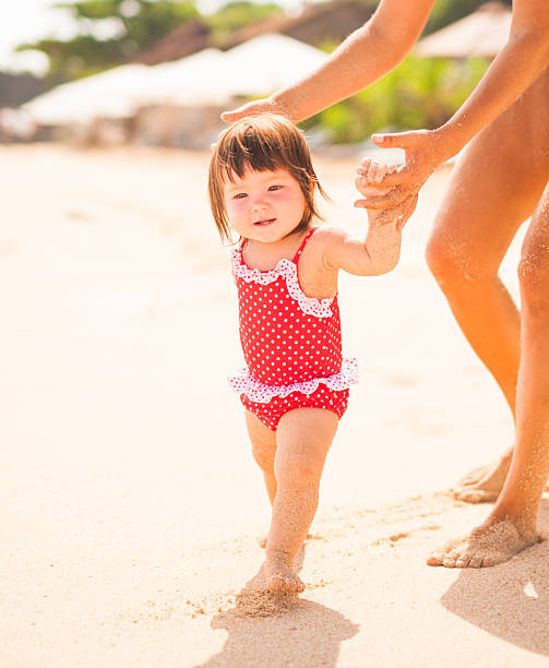 istock baby and mother on a beach 172332743