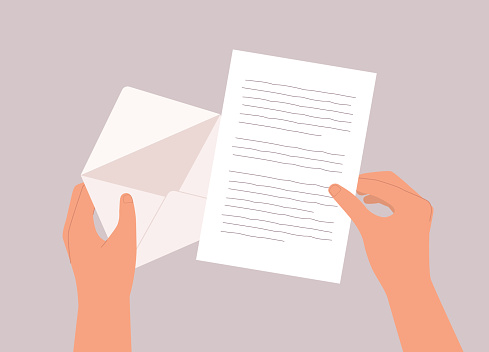 A Person’s Hand Opening A Letter From An Envelope. Isolated On Color Background.