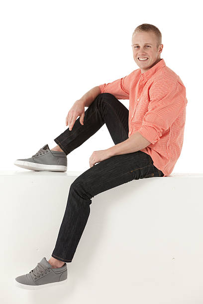 istock Man sitting on the ledge of a wall and smiling 172333995