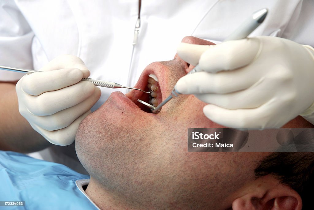 At the dentist Debntist working in pacient's mouth.Many more at: Adult Stock Photo