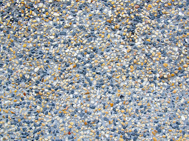 concrete wall with little stones stock photo