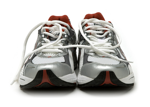 A pair of brand new running shoes on studio white, all logos and brand markings have been removed.