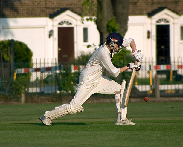 Playing cricket A young cricketer playing a forward defensive shot cricket player photos stock pictures, royalty-free photos & images