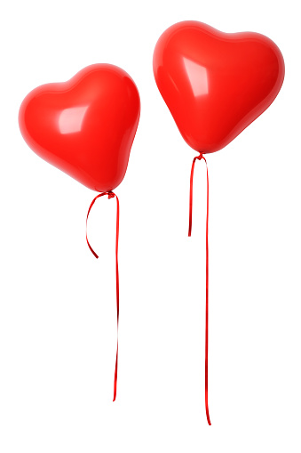 Two shiny red heart shape balloons isolated on a white background with clipping path.