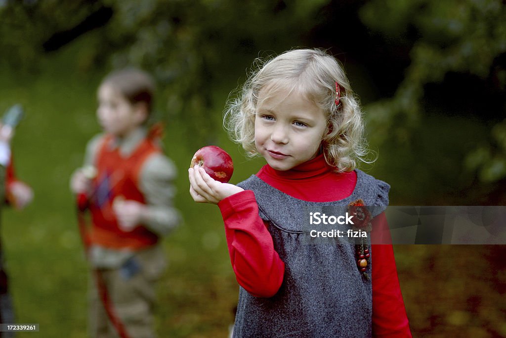 girl with an apple Lovely little  girl  eating  red apple Apple - Fruit Stock Photo