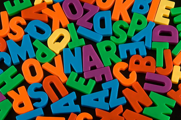 istock Various colors of alphabet pieces isolated on black 172339607