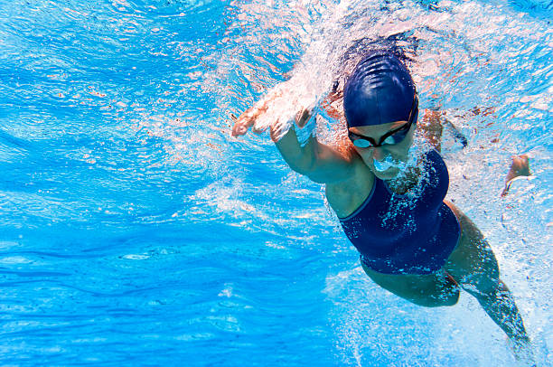Swimmer Underwater image of swimmer in action one piece swimsuit photos stock pictures, royalty-free photos & images