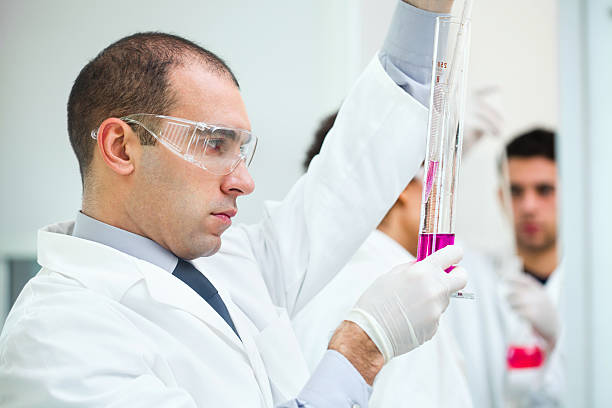 istock Man performing scientific experiment in a laboratory 172340124