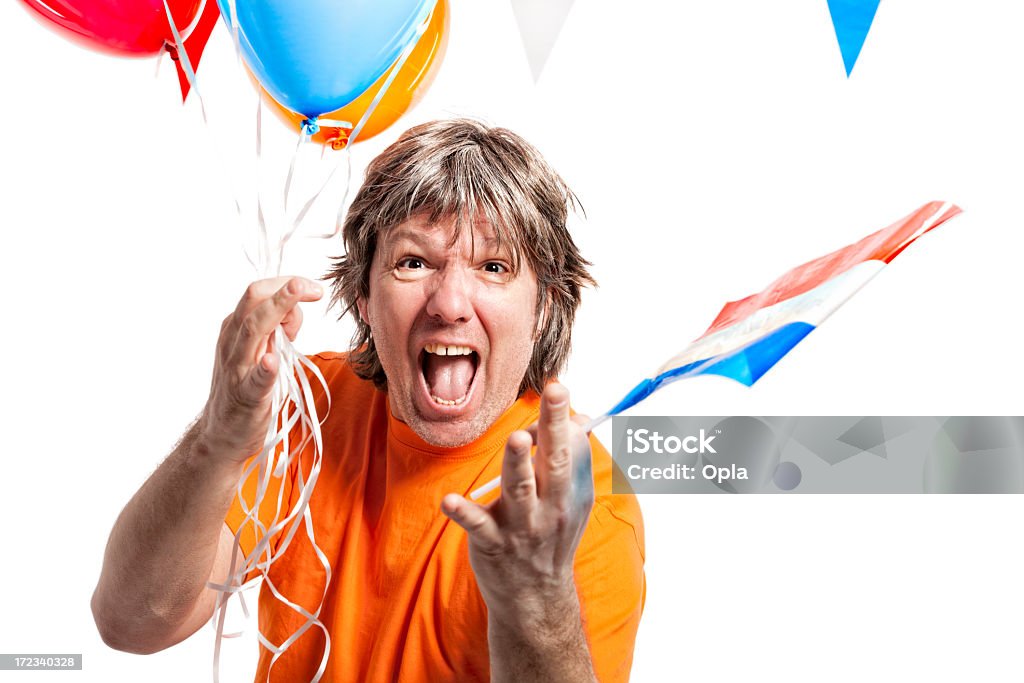 Orange fan celebrating Orange fan celebrating. Dressed in orange with Dutch flag and helium balloons.    Fan - Enthusiast Stock Photo