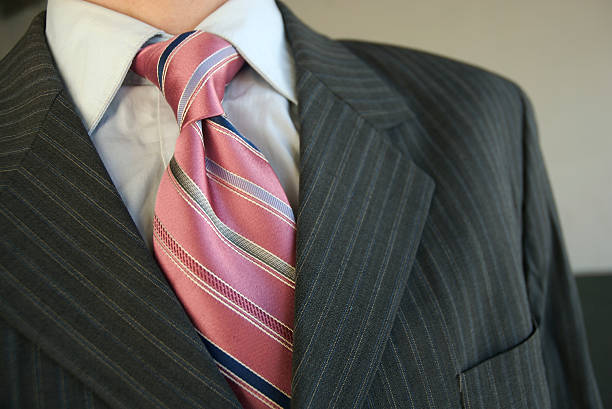 ビジネスマンのクローズアップピンクタイグレイのピンストライプスーツ - necktie close up suit lapel ストックフォトと画像