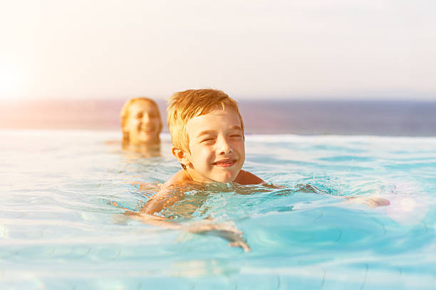 istock Little boy swimming in infinity pool 172340768