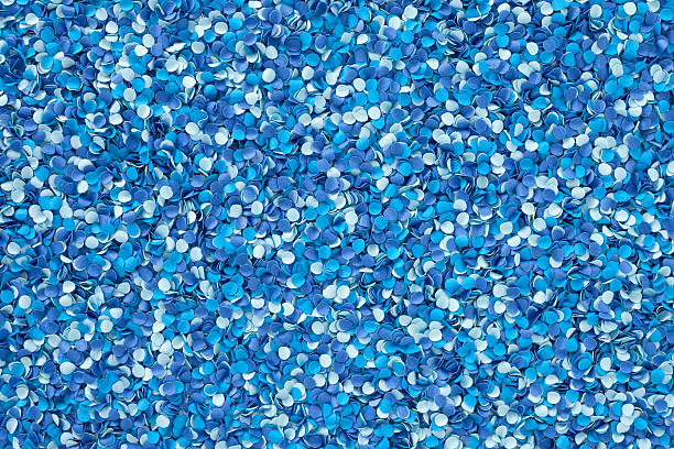 Blue punched paper dots Lots of paper little circles in blue shades hole puncher stock pictures, royalty-free photos & images