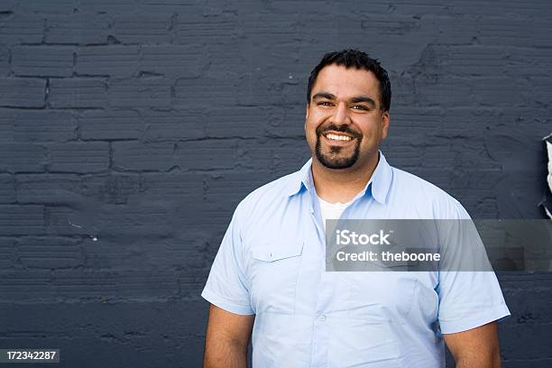 Handsome Dark Man Smiling At The Camera Stock Photo - Download Image Now - Textured, Wall - Building Feature, One Person