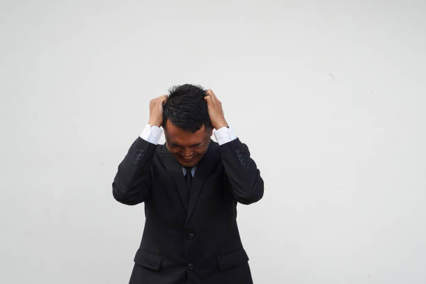 Portrait Young Asian businessman stress, dizziness, headache isolated on white background