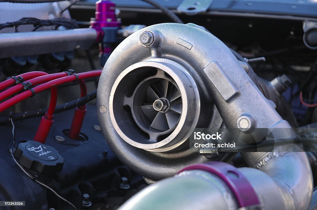 Huge Turbocharger A massive turbocharger on the engine of a race car. Turbocharger Stock Photo