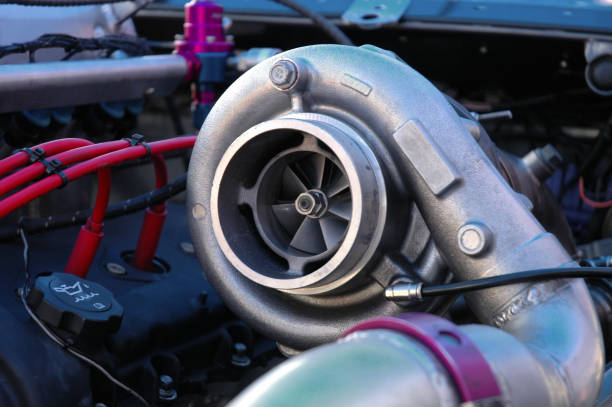 Huge Turbocharger A massive turbocharger on the engine of a race car. supercharged engine stock pictures, royalty-free photos & images