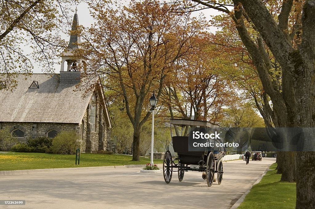 Romantic Escape "Young couple in a horsedrawn carriage on Mackinac Island,  Michigan. The  island is auto-free since 1898" Mackinac Island Stock Photo
