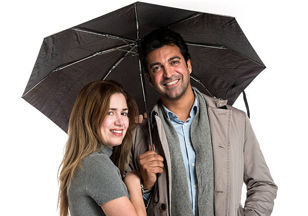 istock Couple standing under an umbrella 172343680