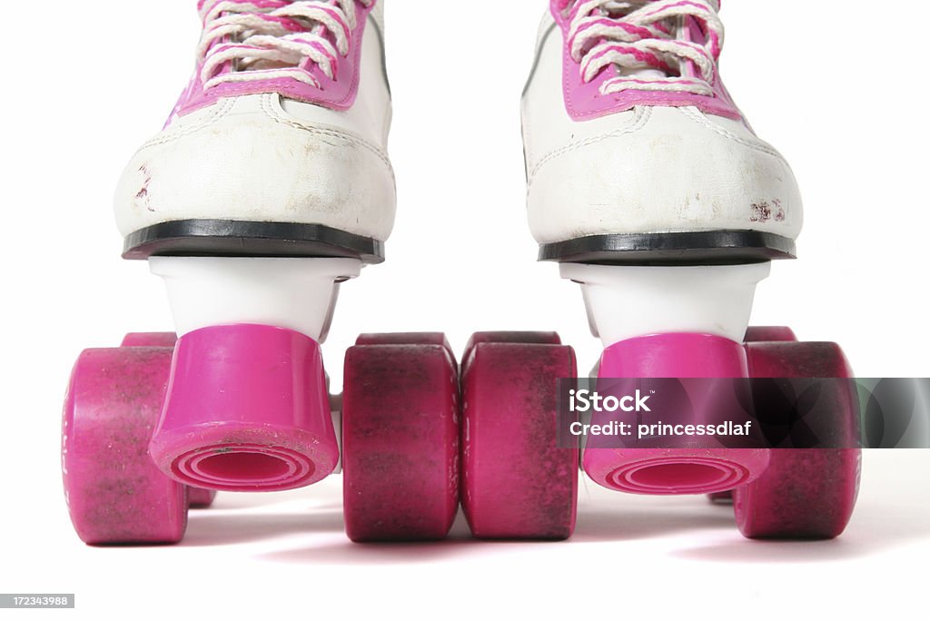 Pink and White Skates Close up of a pair of pink and white children's roller skates on a white background Cut Out Stock Photo