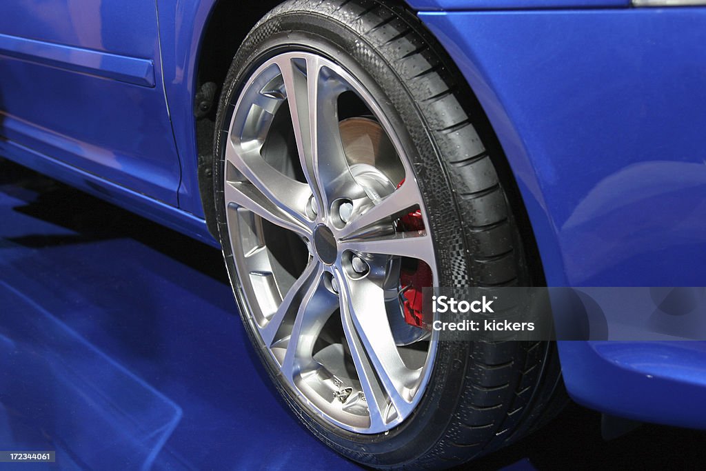 Sports car alloy wheel Blue sports car´s alloy wheel with red brake. Car Stock Photo