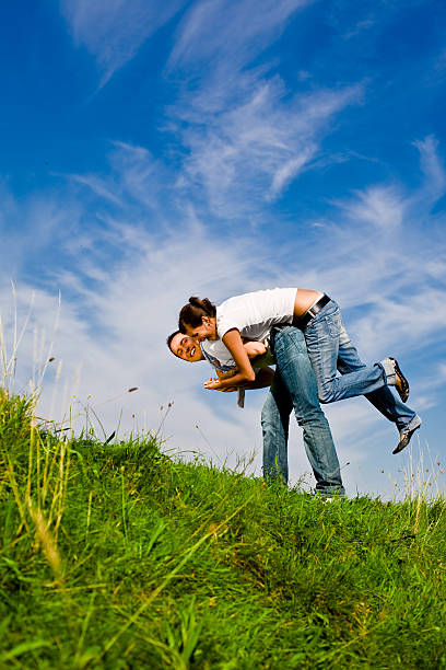 istock young couple play in a grass field 172344706